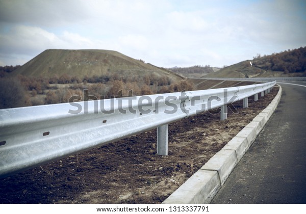 Steel guard rail barrier on the motorway without\
reflective sign