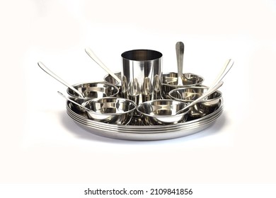 Steel home utensils with selective focus isolated on white background.