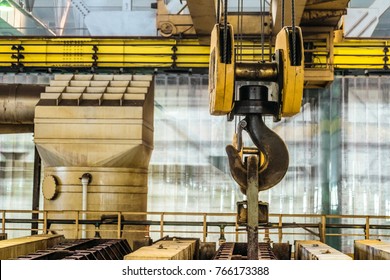 Steel hook of overhead crane over industrial equipment - Shutterstock ID 766173388