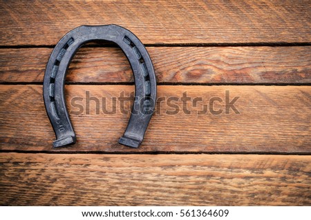 steel horseshoe on wooden background