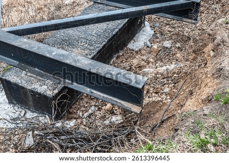 Steel I-beam on concrete foundation. Pedestrian bridge construction.