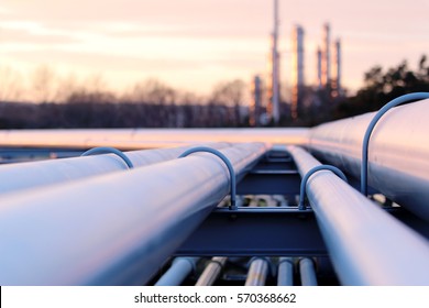 steel long pipes in crude oil factory during sunset - Shutterstock ID 570368662