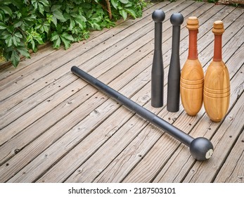 Steel Mace, Steel Clubs And Wooden Indian Clubs On A Backyard Deck, Functional Fitness Concept