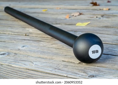 Steel Mace (or Macebell) On A Wooden Deck, Fitness Concept Using Unconventional Equipment