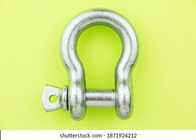 Steel Metal Rigging Shackle On Green Background. Professional Rigging Gear.