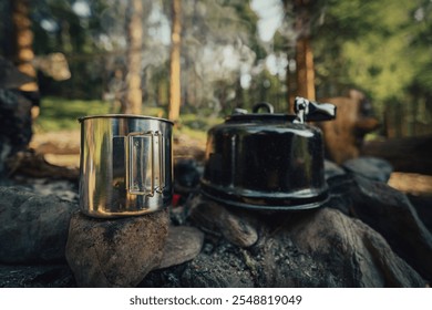 steel mug and kettle near campfire, close up - Powered by Shutterstock