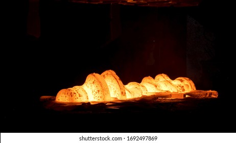 Steel Quenching At High Temperature In Industrial Furnace At The Workshop Of A Forge Plant. Scene. Process Of Cooling, Heat Treatmen, Blacksmith And Metallurgical Industry, Steelmaking.