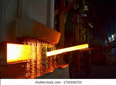 Steel quenching at high temperature in industrial furnace at the workshop of a forge plant. Process of cooling, heat treatmen. Blacksmith and metallurgical industry, hot rolling mill. Small sharpness - Powered by Shutterstock