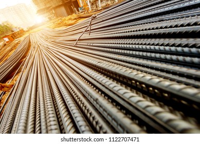 steel rebar for reinforcement concrete at construction site with house under construction background