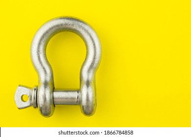 Steel Rigging Shackle On Yellow Background With Space For Text.