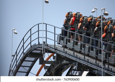 Steel Roller Coaster Going Uphill On A Clear Day.