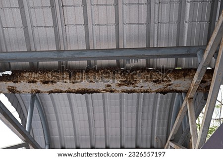 The steel roof structure is rusted and corroded due to a long time waiting for repairs. and unsafe