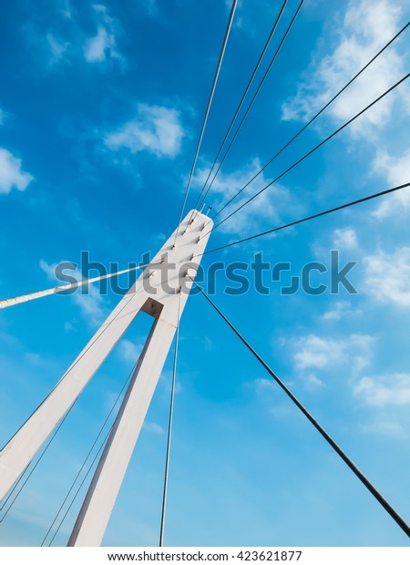 Steel rope bridge\
and cable sling of bridge. Rope bridge with blue sky. Architecture\
abstract with rope\
bridge.