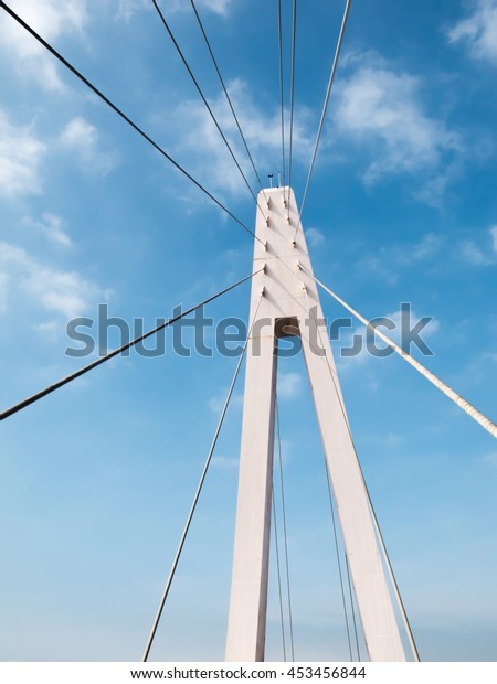Steel rope bridge\
and cable sling of bridge. Rope bridge with blue sky. Architecture\
abstract with rope\
bridge.