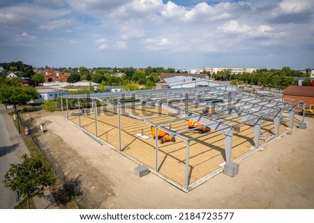 a steel scaffold for a warehouse is erected on a construction site