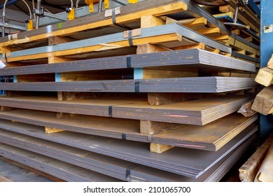 Steel Sheets In Warehouse, Rolled Metal Product. Sheets Of Metal Are Stacked On A Pallet. Many Pallets Of Sheet Metal Of Different Thicknesses Are Stacked On Top Of Each Other.