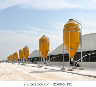 ํํYellow steel silo system for feeding animals on the farm.
