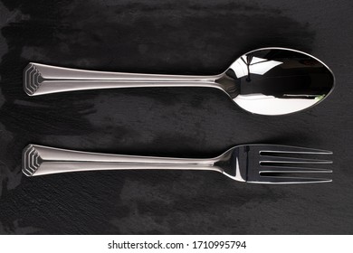 Steel Silver Fork Spoon Isolated On Black Glass