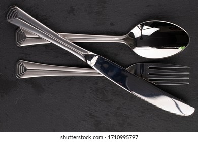 Steel Silver Spoon Fork Knife Isolated On Black Glass