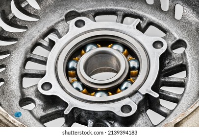 Steel Single-row Radial Ball Bearing With A Plastic Cage. Detail Of Machine Rolling Element In Case From Aluminum Alloy With Cooling Holes Inside Metal Part Of Automotive Alternator. Machine-building.