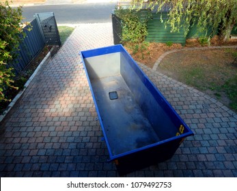 Steel skip of waste management in a front yard of a home
