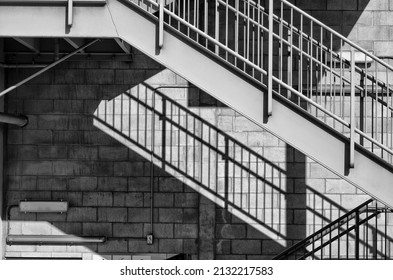 Steel Staircase in Black and White.  Exterior cinderblock building for use as a backdrop.