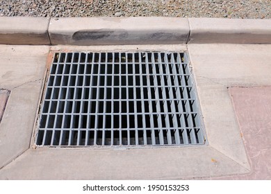 Steel Storm Drain Grate In Concrete Pavement With Concrete Curb