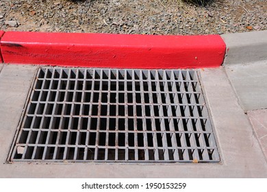 Steel Storm Drain Grate In Concrete Pavement With Concrete Curb