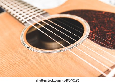 Steel String Acoustic Guitar With Cedar Top And Intricate Details.