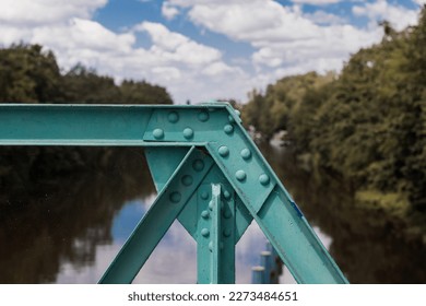 Steel structure of the bridge on the hydrotechnical facility in Wrocław, water structure, riveted structure, steel beams on the river weir