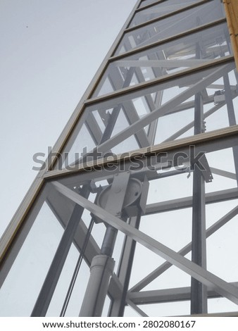 Steel structure of an elevator shaft mounted on the exterior wall of the building