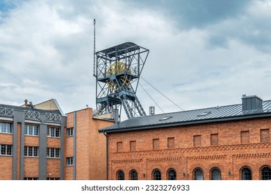 A steel structure of the shaft and a brick post-industrial building. Queen Louise Adit Carnall Zone. Zabrze, Poland