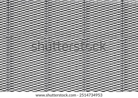 Steel surface with a repeated, geometric pattern of perforations resembling small, elongated diamond shapes. The design creates a textured, industrial look.