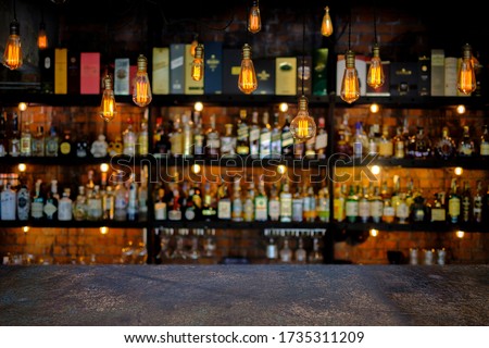 Steel table with soft focus liquor bar background