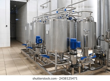 Steel tanks for mixing alcoholic beverages at the winery. Food industry
 - Powered by Shutterstock