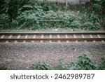 Steel train tracks supported by gravel stones for enhanced stability