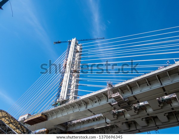 A a steel truss cantilever bridge with steel\
wires used to maintain its\
shape.