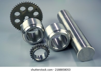 Steel turning and milling parts and gears on a dark background. Metal production - Shutterstock ID 2188858053