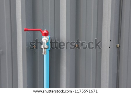 steel water faucet or tab on iron wall with copy space for text.