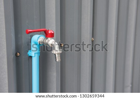 steel water faucet or tab on iron zinc wall with copy space for text.