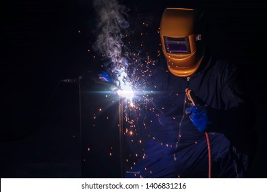 Steel Welding Repair. A craftsman is welding with workpiece steel. Working person About welder steel Using electric welding machine and safety equipment in factory industry.
