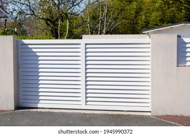 steel white slide gate aluminum portal with blades of suburban house - Shutterstock ID 1945990372