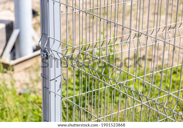 Steel wire lattice fence. Sectional metal fencing.\
Close-up. Selective focus