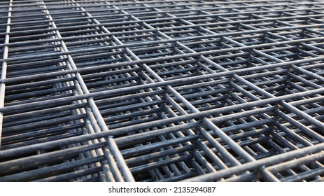 Steel wire mesh pile. BRC welded wire mesh for slab construction in natural light top view. Selective focus