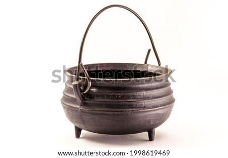 steel witch cauldron, Halloween decorative object on isolated white background.