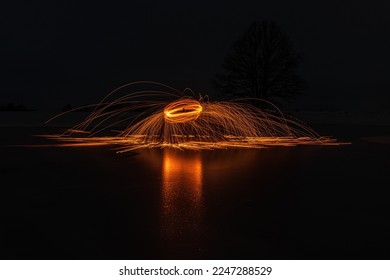 Steel wool circle drawing fireworks  steel wool spinning makes reflection the ice 