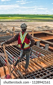 Steel Workers Installing Rebar In A Concrete Form For Casting A Concrete Post Tension Integral Pier Cap, The Steel Girders Are Encased In The Concrete Pier And Not Attached To The Top Of The Pier Cap