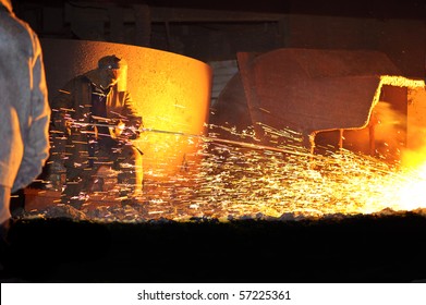 Steelmaker Burns Oxygen Opening for Producing of Cast-!ron from a High Furnace. Iron and Steel Metallurgical Plant. - Powered by Shutterstock