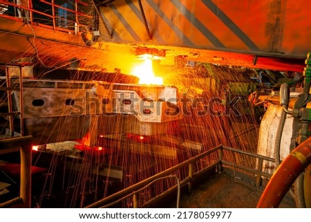 Steelmaker at ingot casting. steelworker at work pouring metal in the workshop, Steelmaking workshop