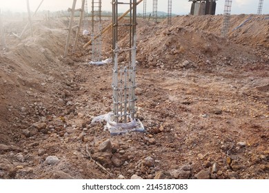 Steel-reinforced Concrete Columns On The Ground For The Next Stage Of Work On The Construction Site.